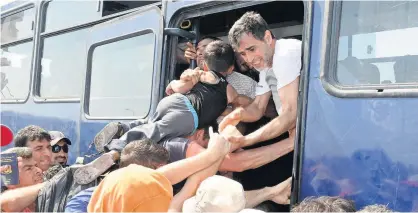  ??  ?? Desperate Syrian refugees causing total chaos, as they leave the Greek island of Lesbos