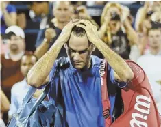  ?? AP PHOTO ?? MAJOR HEADACHE: Roger Federer walks off the court after losing to Tommy Robredo last night in the fourth round of the U.S. Open.