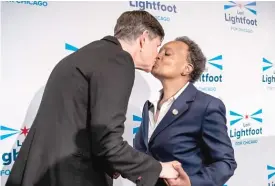  ?? ASHLEE REZIN/SUN-TIMES ?? Mayor Lori Lightfoot kisses her wife, Amy Eshleman, at her election night rally on Tuesday after conceding to Paul Vallas and Brandon Johnson.