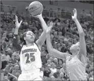  ?? AP/TIMOTHY D. EASLEY ?? Louisville guard Asia Durr (left) shoots over Tennessee defender Jordan Reynolds during the second half of their game in the Oklahoma City Regional of the NCAA Women’s Tournament on Monday. Durr’s 23 points carried the Cardinals to a 75-64 victory.