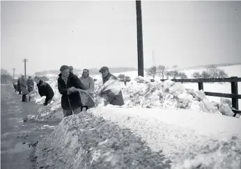  ??  ?? Gangs of workmen get to work clearing parts of the road near Warden Law in January 1963.