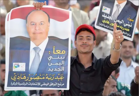  ?? PICTURE: MOHAMED
SAYAGHI / REUTERS ?? ONE-HORSE RACE: A man carries a poster of Yemeni Vice-president Abd-rabbu Mansour Hadi during an election rally in Sana’a yesterday. Hadi is the sole candidate in polls scheduled for today. The new president will rule for a two-year transition­al...