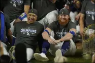  ?? ERIC GAY - THE ASSOCIATED PRESS ?? FILE - In this Oct. 27, 2020file photo, Los Angeles Dodgers manager Dave Roberts and third baseman Justin Turner pose for a group picture after the Dodgers defeated the Tampa Bay Rays to win the baseball World Series in Arlington, Texas. Roberts isn’t sure Turner or former AllStar pitcher David Price will play with the Los Angeles Dodgers in 2021.