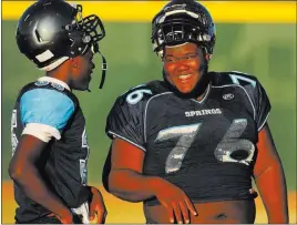  ?? Josh Holmberg ?? Las Vegas Review-journal Offensive lineman Shaun Greene, right, talks to Jessie Bush during practice Wednesday at Canyon Springs High School.