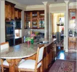  ??  ?? The chef’s-quality kitchen has custom cabinetry, stainless-steel appliances and a wet bar.