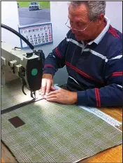  ??  ?? Skill: A craftsman works on a leather trim