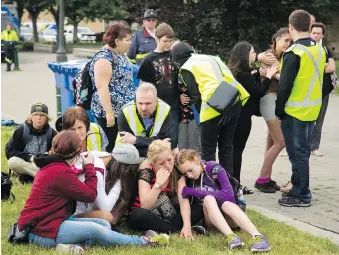  ??  ?? Canadian Mental Health Associatio­n workers talk to distraught students in Woodstock in June 2016, when the area was embroiled in a youth suicide crisis that claimed the lives of five teens in four months.