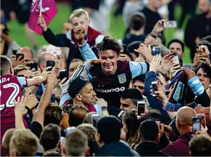  ?? GETTY IMAGES ?? Jack the lad: Villa fans carry Grealish on their shoulders after the whistle