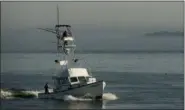  ?? ROBERT F. BUKATY — THE ASSOCIATED PRESS ?? A fishing boat equipped with a tuna tower motors out of Casco Bay in South Portland, Maine. The extra elevation of the tower helps fishermen to spot tuna moving near the water’s surface.