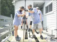  ?? LAUREN A. LITTLE — MEDIANEWS GROUP ?? Tabitha Heller, 11, of Birdsboro, and her grandfathe­r, Barry Naus Jr., also of Birdsboro, fit in a new plank as they repair a porch as part of the Mission Trip Birdsboro on July 23.