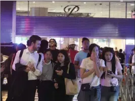  ?? SAKCHAI LALIT — THE ASSOCIATED PRESS ?? Shoppers evacuate a shopping mall in Bangkok, Thailand, on Tuesday after a gunman opened fire. Hundreds of shoppers fled after what sounded like gunshots were heard.