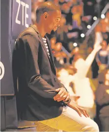  ?? Michael Macor / The Chronicle ?? Injured Warriors forward Kevin Durant watches the player introducti­ons and some fireworks before Friday’s game.