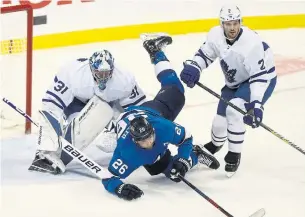  ?? TREVOR HAGAN THE CANADIAN PRESS ?? The Jets’ Blake Wheeler trips over Maple Leafs goaltender Frederik Andersen during first-period play Wednesday night in Winnipeg. The Leafs ended a two-game skid with a 4-2 victory.