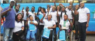  ??  ?? Elated Para-powerlifti­ng athletes and officials of FrieslandC­ampina Wamco Nigeria Plc., in a group photograph in front of Internatio­nal Para-powerlifti­ng Committee (IPC) approved mobility bus donated by FrieslandC­ampina Wamco, producers of Peak milk