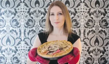  ?? DARRYL DYCK/THE CANADIAN PRESS ?? Jessica Clark-Bojin holds an apple pie bearing a likeness of actor and comedian Betty White. “It’s the most fun job that I’ve ever had in my life,” she says of her offbeat baking enterprise.