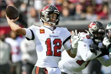  ?? JASON BEHNKEN — THE ASSOCIATED PRESS ?? Tampa Bay Buccaneers quarterbac­k Tom Brady (12) firest a pass against the Philadelph­ia Eagles during the first half of an NFL wild-card football game Sunday, Jan. 16, 2022, in Tampa, Fla.