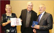  ??  ?? Fr. Denis Stritch PP making a presentati­on to Ann and Henry Keogh on the occasion of their retirement from Rockchapel Post Office.