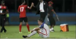  ?? REBECCA BLACKWELL — THE ASSOCIATED PRESS ?? The United States’ Matt Besler, squats on the pitch after losing 2-1 against Trinidad and Tobago during a 2018 World Cup qualifying soccer match in Couva, Trinidad.