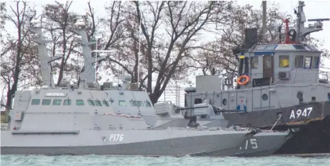  ?? (Alla Dmitrieva/Reuters) ?? UKRAINIAN NAVAL SHIPS, recently seized by Russia’s FSB security service, are anchored in a port in Kerch, Crimea, on Wednesday.