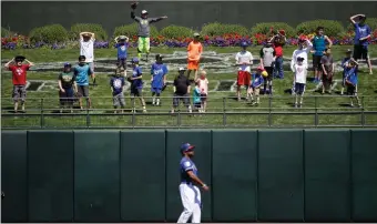  ?? AP PHOTO/JAE C. HONG, FILE ?? In this file photo, young baseball fans watch as Texas Rangers center fielder Delino DeShields throws the ball away during the team's spring training baseball game against the Kansas City Royals in Surprise, Ariz. Baseball fans often schedule spring...