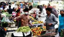  ?? PIC/NAVEEN SHARMA ?? Residents purchase fruits & vegetables during lockdown in the wake of Coronaviru­s pandemic in New Delhi on Tuesday