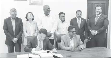  ?? ?? Prime Minister Mark Phillips, Senior Minister within the Office of the President with responsibi­lity for Finance and Public Service, Dr Ashni Singh and Minister within the Ministry of Public Works, Deodat Indar with representa­tives from GUYSOL, SUMEC and IDB. (DPI photo)