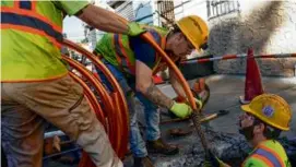  ?? SETH WENIG/ASSOCIATED PRESS/FILE ?? Workmen prepared to replace older water pipes with new copper ones in Newark, N.J., in 2021.