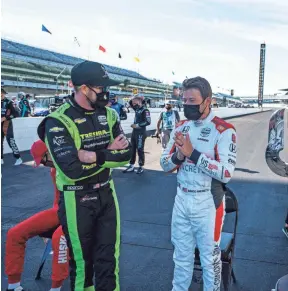  ?? MICHAEL CONROY/AP ?? Charlie Kimball, left, talks with Marco Andretti on Friday ahead of the 104th running of the Indianapol­is 500.