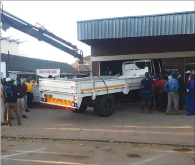  ??  ?? A rescue crane pulls a learner’s truck after it rammed into a building in Gweru on Wednesday