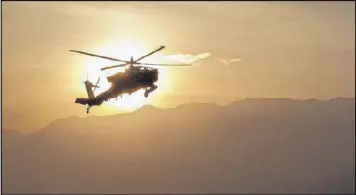  ?? CAPT. JOHN GIAQUINTO / U.S. ARMY ?? An Army Apache helicopter flies over Afghanista­n. The Army has launched an investigat­ion into the deaths of two elite Army Rangers.