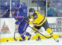  ?? JULIA MALAKIE / LOWELL SUN ?? Umass Lowell’s Charlie Levesque, left, battles on the boards with Merrimack’s Liam Walsh last Saturday.