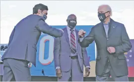  ?? CAROLYN KASTER/ASSOCIATED PRESS ?? President-elect Joe Biden campaigns in Atlanta on Monday for U.S. Senate candidates Raphael Warnock, center, and Jon Ossoff.