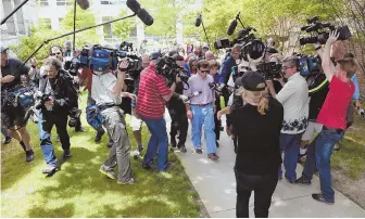  ?? STAFF PHOTO BY FAITH NINIVAGGI ?? PURSUED: Conrad Roy, father of Conrad Roy III is surrounded by media as he is escorted by a court officer after Michelle Carter was found guilty.