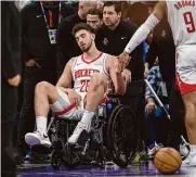  ?? Randall Benton/associated Press ?? Houston’s Alperen Sengun is wheeled from the arena after injuring his right knee and ankle Sunday.