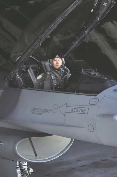  ?? An Rong Xu FOR THE Washington Post ?? Lt. Col. Hsiao Yi-chiao of the Taiwanese air force inside an F-16 jet. He is teaching the next generation of fighter pilots, crucial for Taiwan as it seeks to build up its reserve of F-16 pilots to resist a potential Chinese military invasion.
