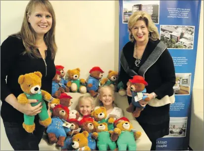  ?? Signal file photo ?? Local resident Marlee Lauffer, right, stands with a teddy bear, during a Henry Mayo Newhall Foundation event. Lauffer was named Woman of the Year Monday on the floor of the California State Senate. Lauffer is president of the Henry Mayo Newhall...