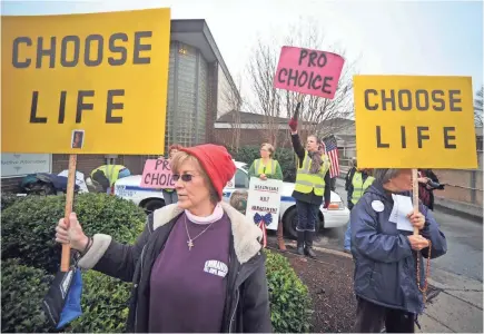  ??  ?? People demonstrat­e outside the Alabama Women’s Center for Reproducti­ve Alternativ­es in Huntsville in 2013.