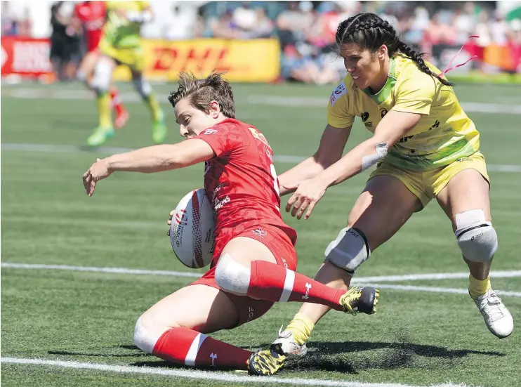  ?? — PHOTOS: GETTY IMAGES ?? Ghislaine Landry tumbles to the ground as she scores a try against reigning Olympic champion Australia. Canada won the semifinal match 17-10.