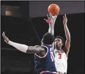  ?? Associated Press ?? USC forward VIncent Iwuchukwu (3) shoots as Arizona center Oumar Ballo defends during the second half on Thursday in Los Angeles.