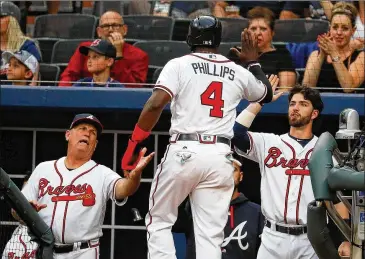  ?? KEVIN C. COX / GETTY IMAGES ?? Veteran Braves players say they hope manager Brian Snitker (left) and his coaching staff return after injuries and midseason trades contribute­d to a disappoint­ing finish this season.