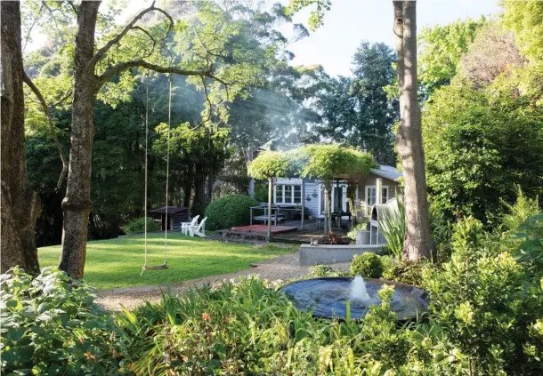  ??  ?? ABOVE Wisteria ‘Macrobotry­s’, which produces breathtaki­ng flowers of 40–50cm long, grows over a pergola at the side of Michael’s house. A swing hangs from a Doryphora sassafras tree, a remnant from an indigenous rainforest. OPPOSITE Michael in his wife...