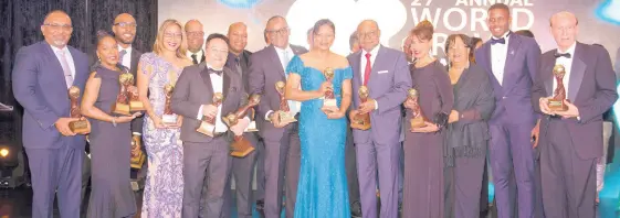  ?? CONTRIBUTE­D ?? Jamaica’s Minister of Tourism Edmund Bartlett (fifth right) poses with the country’s travel partners at the World Travel Awards Caribbean at the Sandals Royal Bahamian in Nassau, Bahamas.
