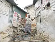  ?? /Reuters ?? Concerned: Johanna Ditsela walks between shacks in Alexandra. Ratings Afrika analyst Leon Claassen says the weak financial stability of Johannesbu­rg and Tshwane might have a detrimenta­l effect on service delivery.