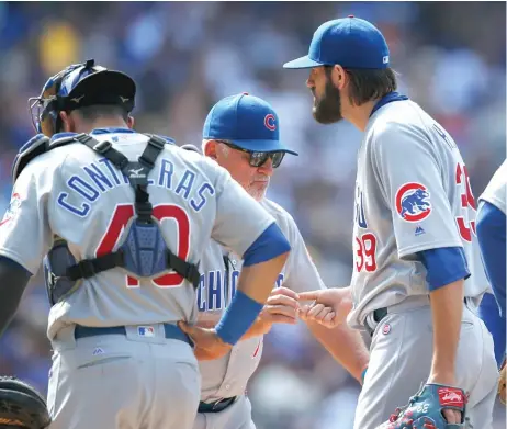  ?? | DAVID ZALUBOWSKI/ AP ?? Cubs manager Joe Maddon takes the ball from starter Jason Hammel ( right) in the fourth inning of the Cubs’ blowout loss Sunday.