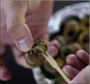  ?? ?? Anton Avramenko holds a cooked snails at his farm in Veresnya, on the outskirts of Kyiv, Ukraine.