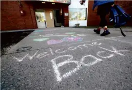  ?? ?? A chalked celebrator­y greeting lined the sidewalk near Lincoln-Eliot Elementary School.