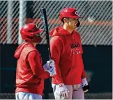  ?? AP ?? Tyler Stephenson (right) awaits his turn in the batting cage alongside Tucker Barnhart. Stephenson’s main focus this spring is on improving behind the plate so he can serve as Barnhart’s backup.