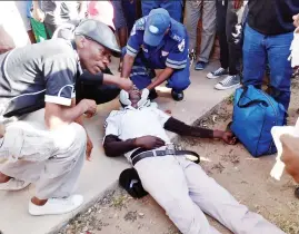  ??  ?? Medics attend to a Highlander­s fan who fell from the terraces during a Premiershi­p match against Shabanie Mine FC at Barbourfie­lds Stadium in Bulawayo on Sunday.