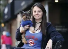  ?? ASSOCIATED PRESS ?? Lauren Pestikas holds her dog Sambuca in Chicago. Since starting treatments with ketamine infusions, she says she feels much better for a few weeks after each session. Her monthly infusions last about 45 minutes and cost $550 each.