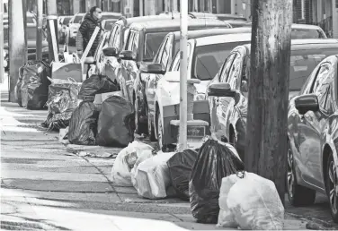  ?? MATT ROURKE/AP ?? Trash sits on the sidewalk for collection in Philadelph­ia last week. Around 10% to 15% of the city’s 900-person sanitation workforce is out on any given day, leading to delays in waste collection, according to Streets Commission­er Carlton Williams.